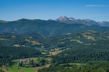 Pic de l'aiguille du midi in the Pyrenees in the distance, with the countryside in the foreground,