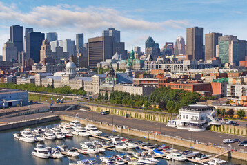 Aerial view of Montreal skyline in summer with yachts port in the foreground