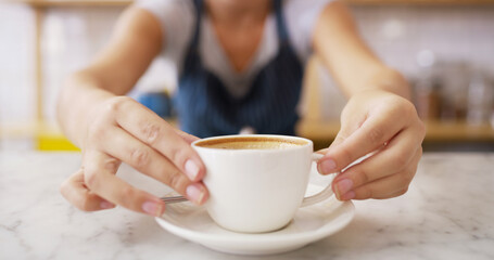 Hands, person and serving coffee at cafe for customer service, espresso drink and order collection. Waiter, closeup and giving beverage for breakfast catering, server helping and hospitality industry