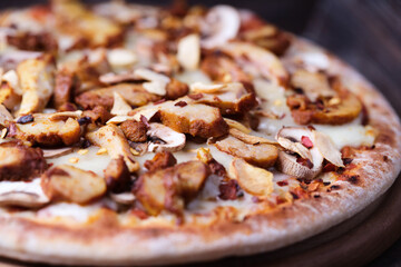 Gyros Pizza with with champignons and mozzarella cheese. Wooden background. Soft focus.