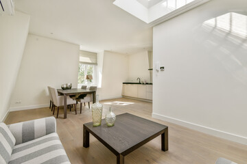 A bright and airy modern living space featuring minimalist decor, a stylish dining area, and natural light streaming through large windows.