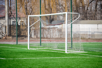 A soccer field with a white goal post