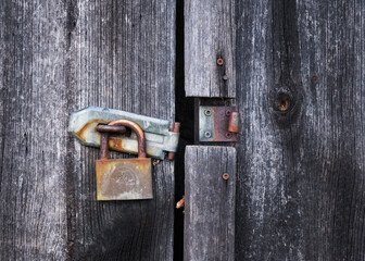 Vintage padlock on an old door