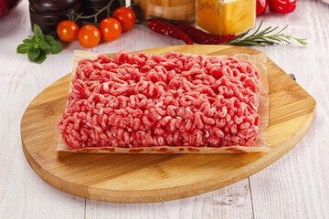 Raw minced beef meat over board