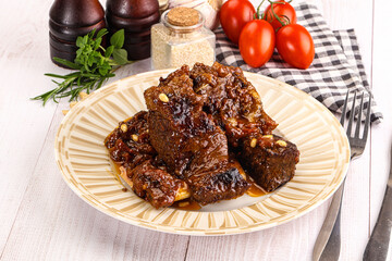Prepared tasty beef ribs with sauce