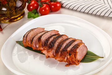Sliced duck breast baked with cherry