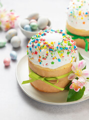 Delicious easter cake decorated with colorful sprinkles and green ribbon