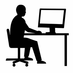 Silhouette of a person working on a laptop at a desk in an office