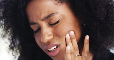 Toothache, sad and face of African woman at home for dental decay, poor oral hygiene and gum health...