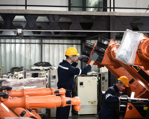 Fototapeta premium Engineer Caucasian male use tablet computer checking robot arm 