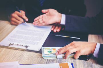 Banker offering loan money for customer and signing a loan contract. Selected focus