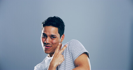 Portrait, space and man with peace sign in studio with positive attitude, confidence or facial...