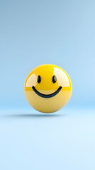 Fototapeta premium A glossy yellow smiley face on a light blue background
