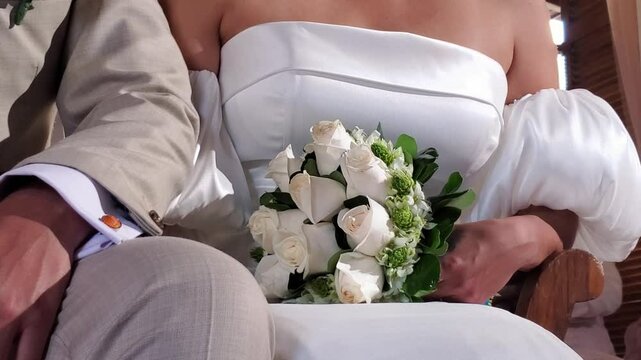 Bridal Bouquet: Couple at Church for romantic Wedding. White Roses Close up