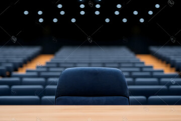 Empty auditorium with single chair on stage