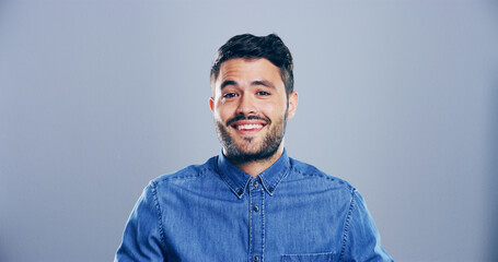 Obraz premium Fashion, studio and portrait of man, trendy and excited for scholarship in university, happy or outfit. Mockup space, blue background and person with stylish clothes, student or guy with smile in USA