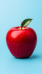 Single red apple with leaf on blue background