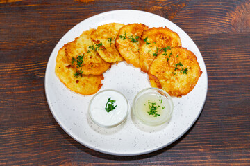 Delicious golden potato fritters served with creamy dips