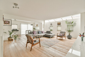 A bright and airy modern living room featuring stylish furniture, a cozy seating area, and decorative plants for a fresh ambiance.