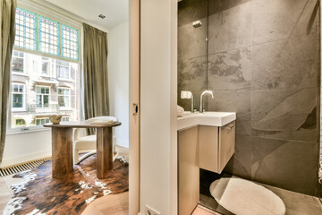 A bright and airy room featuring stylish furniture, large windows, and elegant decor, merging...