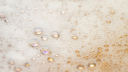 abstract bubbles and foam texture background on gold yellow, full frame, copy space