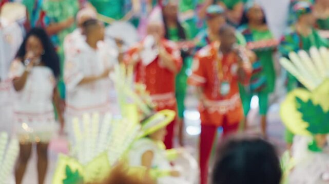 Brazilian carnival. Naturally blurred footage of the brazilian carnival and parade of school of samba performing on a sambodrome. People dance and celebrate on night parade of school of samba