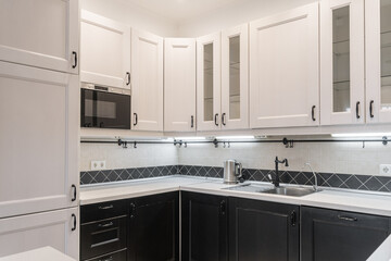 design of modern built-in kitchen in minimalist style. kitchen set with white and dark wooden...