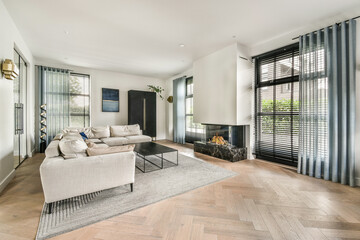 A stylish modern living room showcasing sleek furniture, abundant natural light, and elegant decor, creating a cozy yet sophisticated atmosphere.