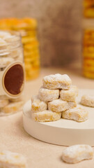 Putri salju cake is a type of dry cake that is shaped like a crescent moon and is topped with powdered sugar like snow.