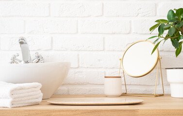 Bathroom podium for bathing and spa product display on wooden table with blurred white brick wall background
