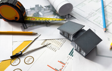Building models and blueprints are placed on work desks in the construction engineering team offices to plan construction to achieve their goals and to simulate building models for clients to see.