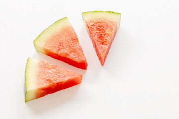 Minimalist Watermelon Triangle Slice on White Surface
