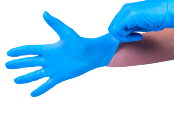 Doctor puts on sterile medical gloves. White background.