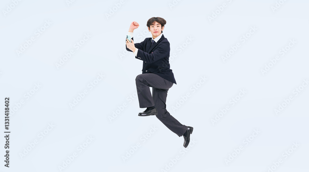 Aufkleber スマホを持ってジャンプする制服を着た男子学生の全身写真（切り抜き背景透過pngも販売しております。↓作成者リンクから「png」で検索してください）