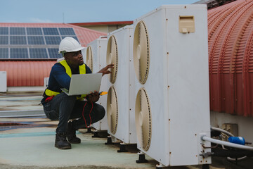 Engineers are checking the air conditioning and cooling system in a commercial building.(PHOTO)