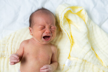 Small newborn baby crying loudly
