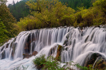Breathtaking Cascading Suzheng Waterfall in UNESCO Jiuzhaigou Park.