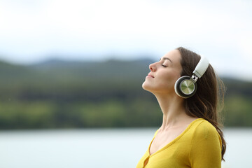 Woman meditating listening audio guide online