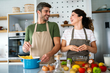 A young couple in love having good time while preparing a breakfast together on a beautiful morning