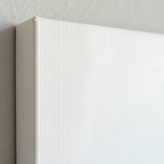 Close up of a corner of a blank white canvas