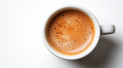 Overhead close up of a coffee cup filled with espresso, showcasing crema and rich brown color against a bright white background.