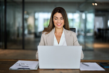 Happy smiling busy mature middle aged professional business woman manager executive looking at...