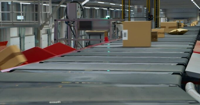 Private and Retail Parcels Navigate an Automated Conveyor Line in a Sorting Center, Ready to be Delivered. Logistics System Operation Flow and Package Handling in a Warehouse