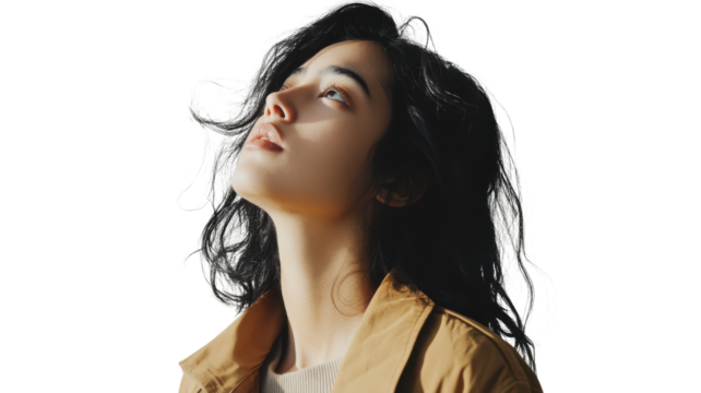 Woman gazing upward with flowing hair, showcasing contemplation and tranquility in a minimalist setting