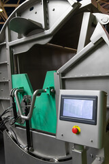 Fototapeta premium Side view of empty clean metal automated slaughter box in modern slaughterhouse or in meat packing plant. Food processing factory. Food and drink industry theme. Copy space.