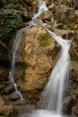 Obraz premium Waterfall texture. Background of the falling purest mountain water. A cascade of blurred movements. A natural neutral background for the design. The concept of life, ecology, environmental protection.