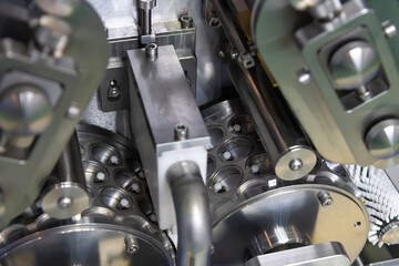 Close-up view of clean metal industrial dumpling and ravioli making machine in food processing factory or in modern commercial kitchen. Soft focus. Food technology theme.