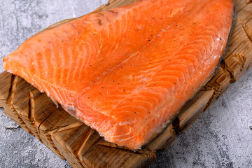 Hot smoked trout fillet on a wooden board