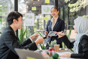 Sustainable Practices and Team Collaboration. A diverse team discussing eco-friendly projects in a modern office setting.