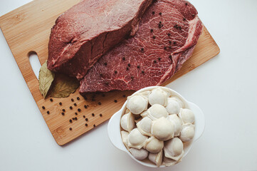 Photo of beef and dumplings in a plate view from above. A stylized image with muted colors is isolated. Not a bright photo of a piece of beef in a cut. High quality photo
